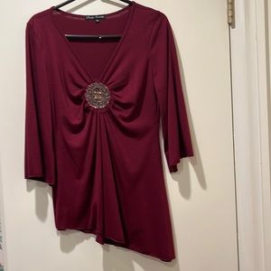 Maroon blouse with beaded embellishment.